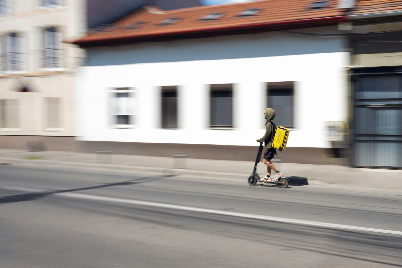 a person riding a scooter down a street